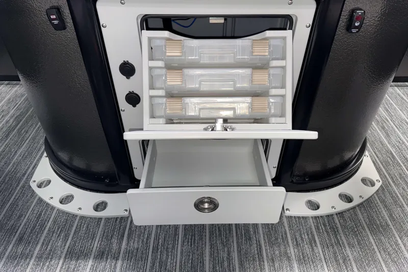 Slide: The Image of 2026 Premier 230 Sunsation Angler Tritoon storage compartments with tackle boxes and drawer. - 14