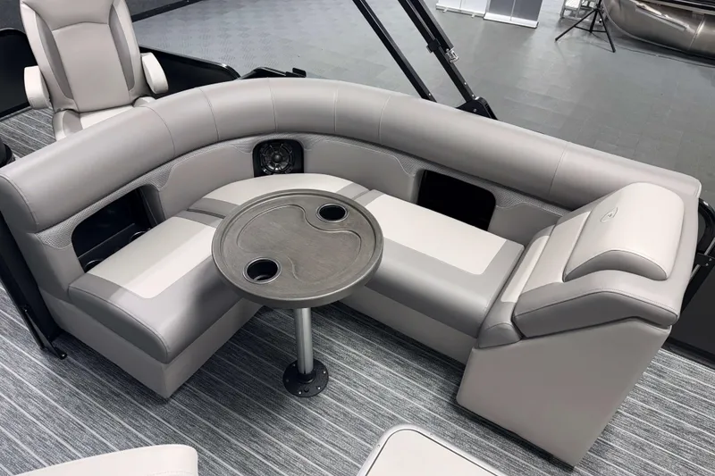 Slide: The Image of Luxurious seating area on 2026 Premier 230 Sunsation Angler 2pt Tritoon with table and cup holders. - 15