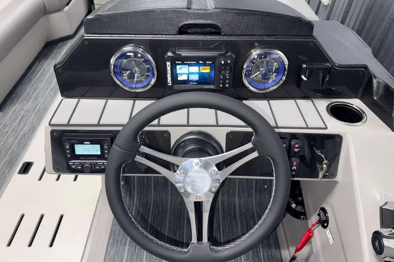 Slide: The Image of 2026 Premier 230 Sunsation Angler Tritoon dashboard with steering wheel and navigation controls. - 17