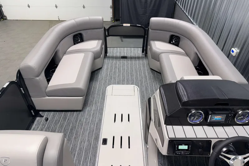 Slide: The Image of 2026 Premier 230 Sunsation Angler Tritoon interior with gray seating and modern dashboard. - 25
