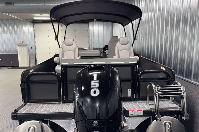 Slide: The Image of 2026 Premier 230 Sunsation Angler Tritoon with 150 HP engine in a metal-walled showroom. - 8