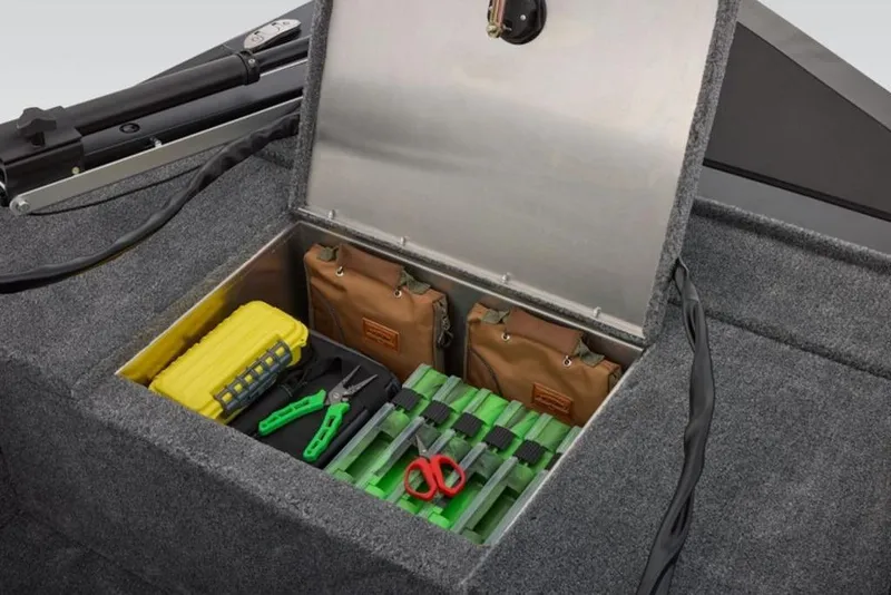 Slide: The Image of 2026 Tracker Panfish 17 boat storage compartment with fishing gear and tools. - 12