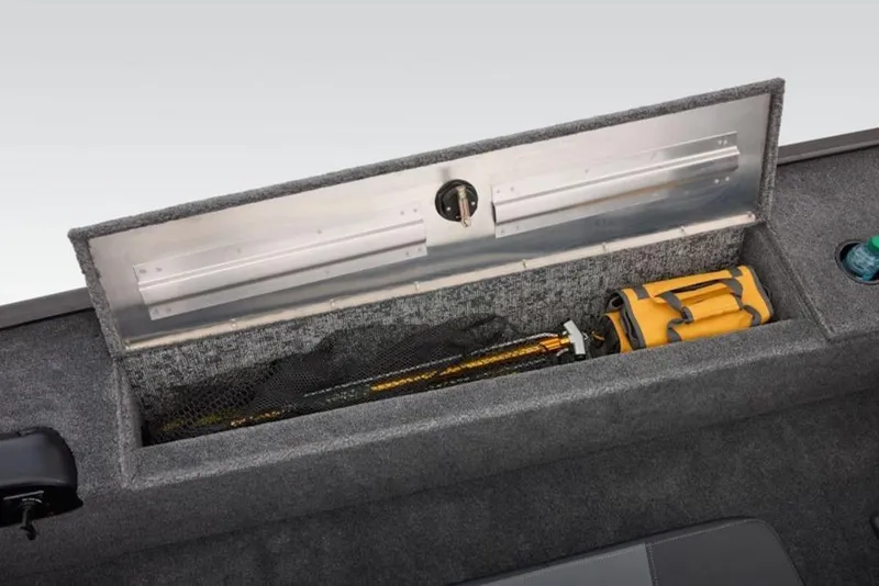 Slide: The Image of 2026 Tracker Panfish 17 boat storage compartment with fishing gear and a yellow bag. - 15