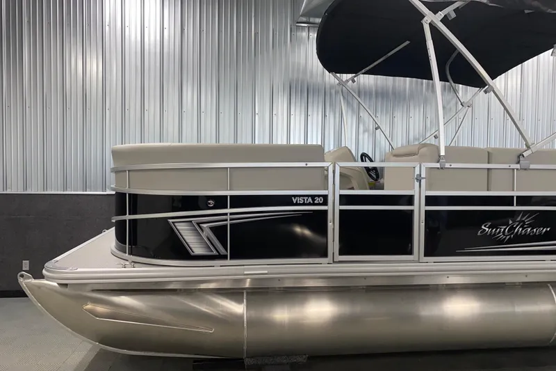 Slide: The Image of 2026 SunChaser Vista 20 CRB pontoon boat with sleek design in a showroom. - 15