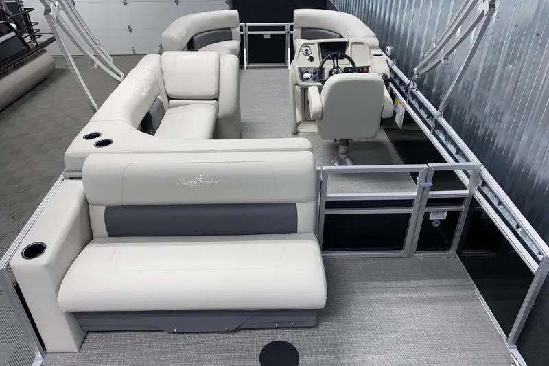 Slide: The Image of 2026 SunChaser Vista 20 CRB pontoon boat interior with plush seating and modern helm. - 2