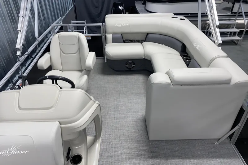 Slide: The Image of 2026 SunChaser Vista 20 CRB pontoon boat interior with plush seating and steering console. - 9