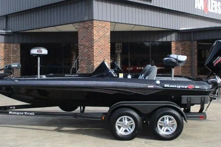 Slide: The Image of 2026 Ranger Z185 boat on trailer, parked outside a brick building. - 1