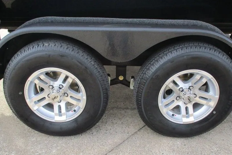 Slide: The Image of 2026 Ranger Z185 trailer wheels, dual axle, silver rims on concrete surface. - 8