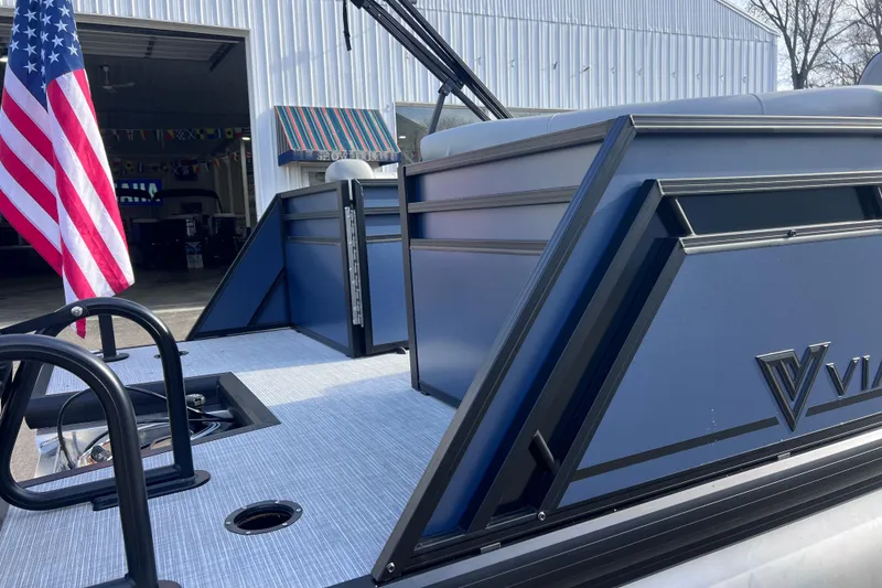 Slide: The Image of 2026 Viaggio V 20U boat with American flag, docked near a warehouse. - 8