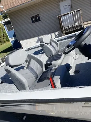Slide: The Image of 2023 G3 Sportsman 1710 boat interior with gray seating and steering wheel. - 4