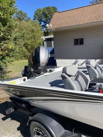 Slide: The Image of 2023 G3 Sportsman 1710 boat with motor, parked outdoors near a house. - 6