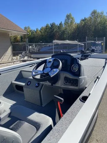 Slide: The Image of 2023 G3 Sportsman 1710 boat interior with steering console, outdoors. - 5