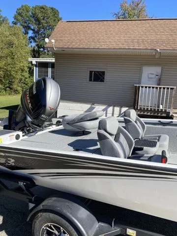 Slide: The Image of 2023 G3 Sportsman 1710 boat with motor, parked near a house. - 9