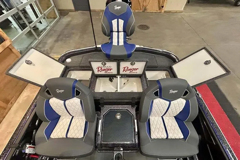 Slide: The Image of 2026 Ranger Z521R Cup-Equipped boat interior with blue and white seats, storage compartments open. - 13