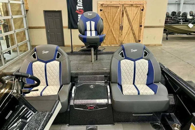 Slide: The Image of 2026 Ranger Z521R Cup-Equipped boat interior with blue and gray seating. - 8