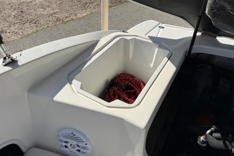 Slide: The Image of Storage compartment in a 2011 Chaparral 186 SSi boat with red rope inside. - 20