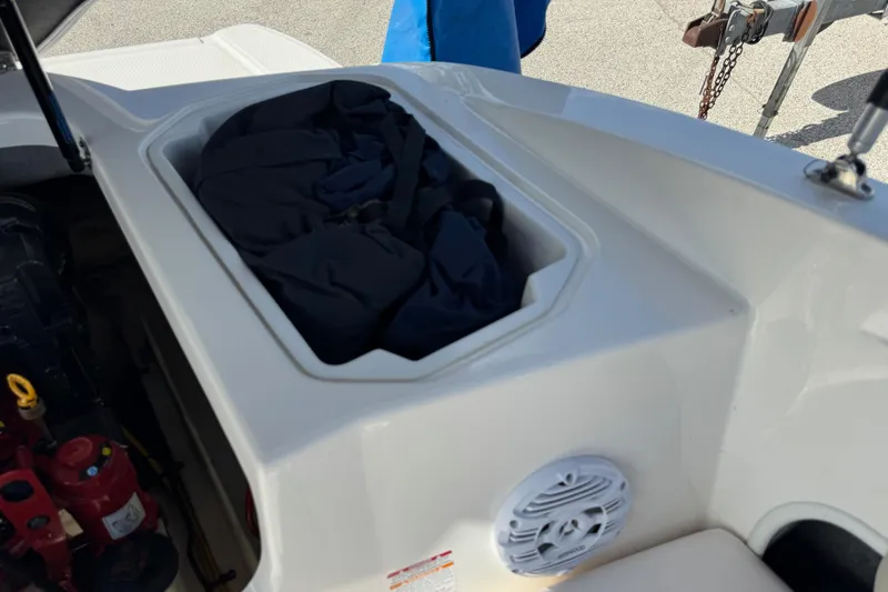 Slide: The Image of 2011 Chaparral 186 SSi boat storage compartment with speaker and equipment. - 21