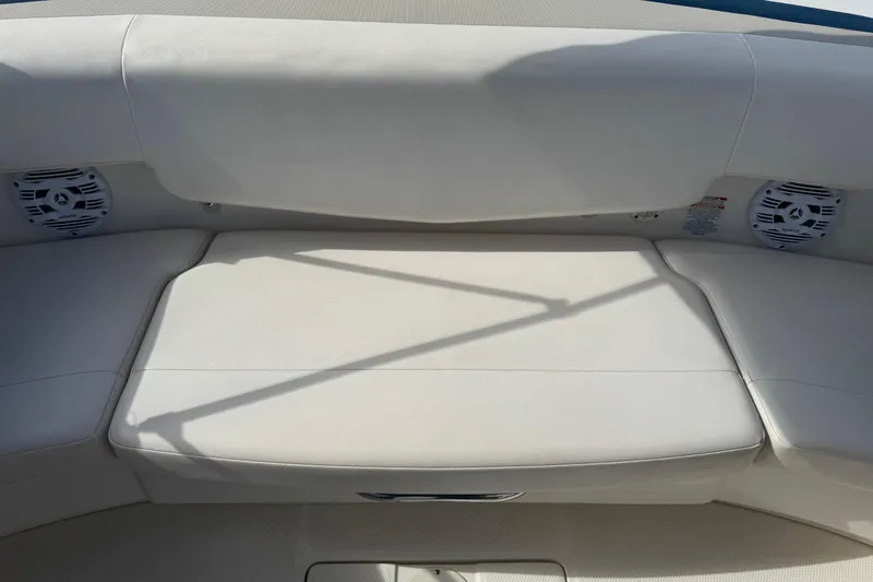 Slide: The Image of 2011 Chaparral 186 SSi boat interior with white seating and speakers. - 3