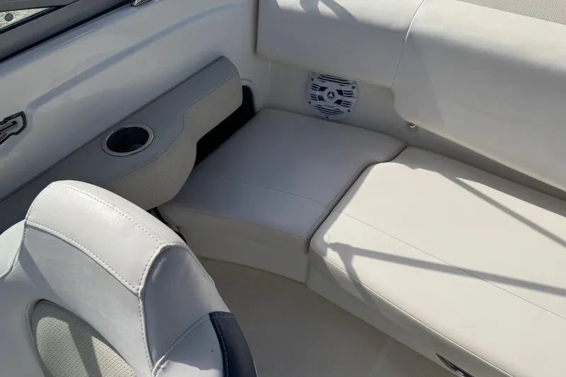 Slide: The Image of 2011 Chaparral 186 SSi boat interior with white seating and speaker. - 4