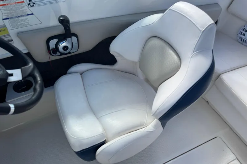 Slide: The Image of 2011 Chaparral 186 SSi boat interior with white captain's seat and steering wheel. - 6