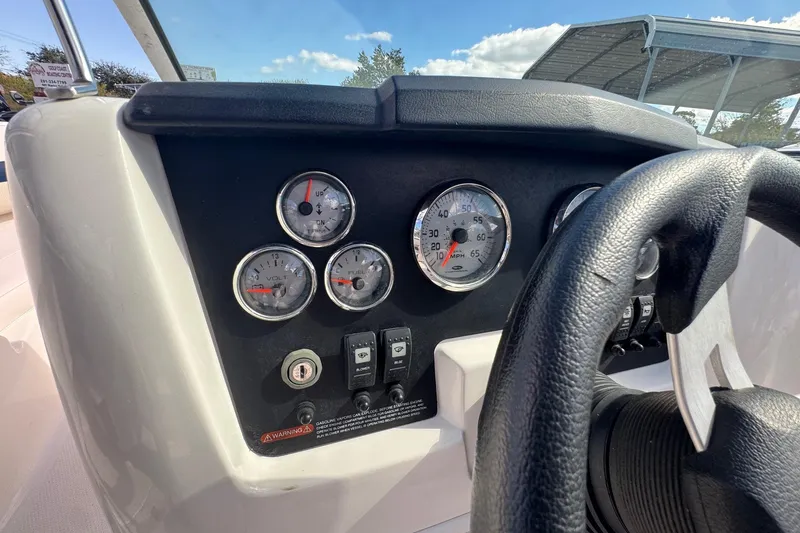 Slide: The Image of Dashboard of 2011 Chaparral 186 SSi boat with gauges and steering wheel. - 8