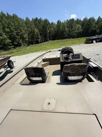 Slide: The Image of 2023 G3 Gator Tough 17 SC boat with dual seats, steering console, and forest backdrop. - 6