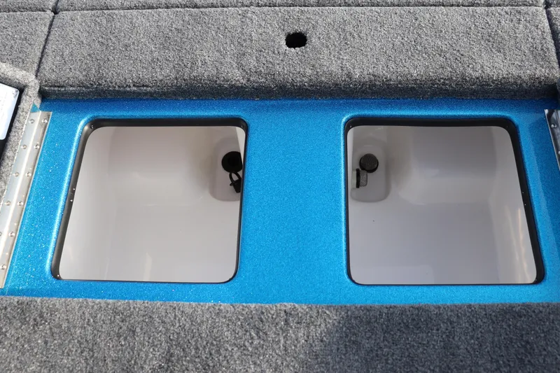 Slide: The Image of 2026 Falcon Boats F205 livewell compartments with blue trim and gray carpet. - 14