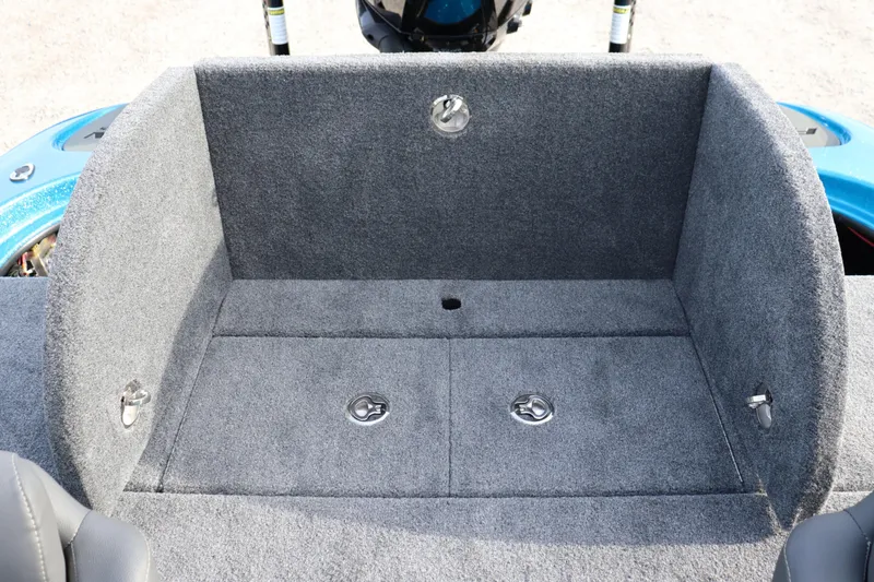 Slide: The Image of 2026 Falcon Boats F205 interior storage compartment with gray carpet and metal latches. - 16