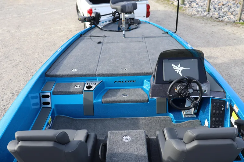 Slide: The Image of 2026 Falcon Boats F205 interior with steering wheel and seating, featuring a sleek blue design. - 17
