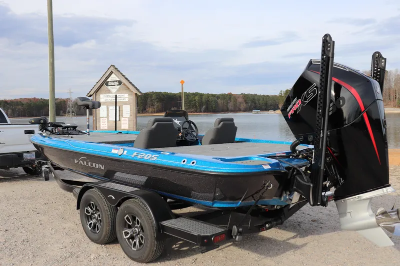 Slide: The Image of 2026 Falcon Boats F205 on trailer by lake, featuring sleek design and powerful engine. - 19