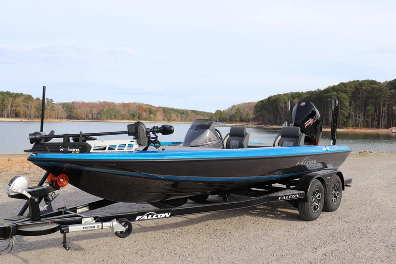 Slide: The Image of 2026 Falcon Boats F205 on a lakeside, featuring a spacious deck and modern equipment. - 2
