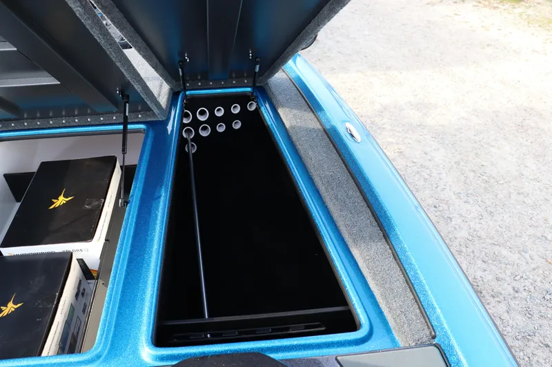 Slide: The Image of Open storage compartment in 2026 Falcon Boats F205, showcasing interior design and rod holders. - 6