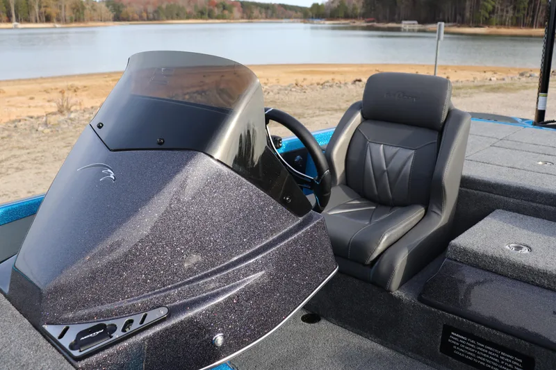 Slide: The Image of 2026 Falcon Boats F205 cockpit with sleek design and comfortable seating by a serene lake. - 8