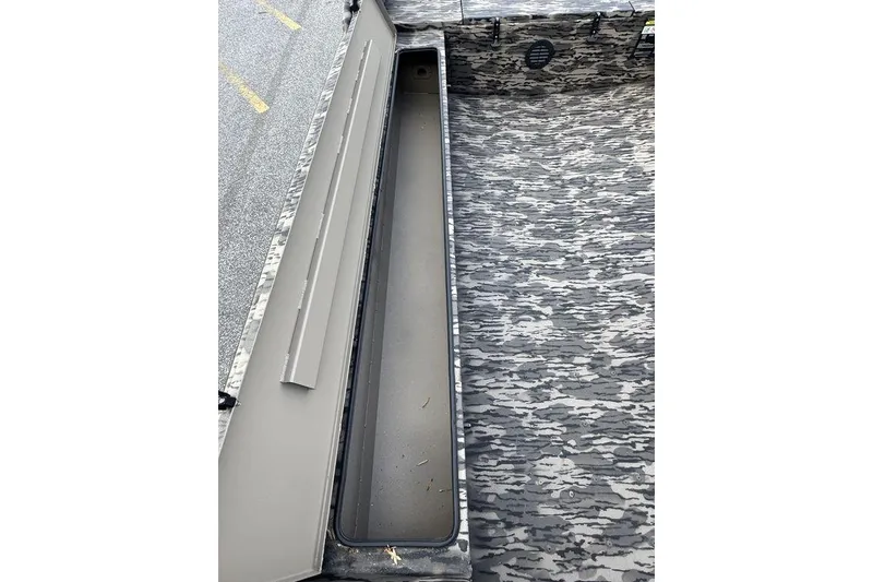 Slide: The Image of 2026 Havoc 1756 boat interior with open storage compartment and camouflage pattern. - 15