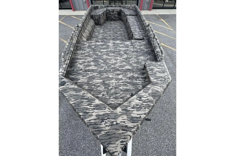 Slide: The Image of 2026 Havoc 1756 boat with camouflage interior, parked outdoors. - 3