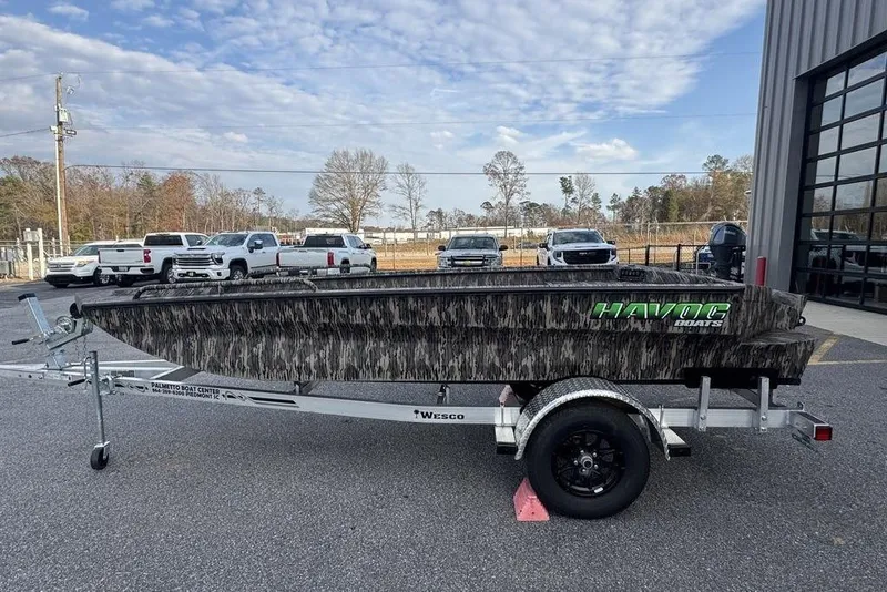 Slide: The Image of 2026 Havoc 1756 boat on trailer, camo design, parked outside dealership. - 4