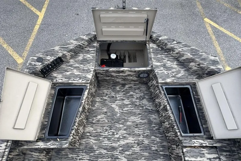 Slide: The Image of 2026 Havoc 1756 boat interior with open storage compartments and camouflage design. - 9