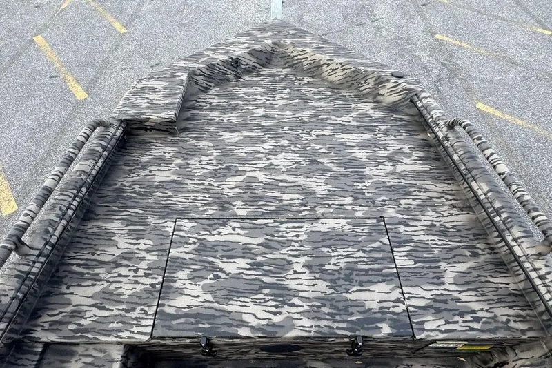 Slide: The Image of Camouflage-patterned deck of a 2026 Havoc 1756 boat in a parking lot. - 11