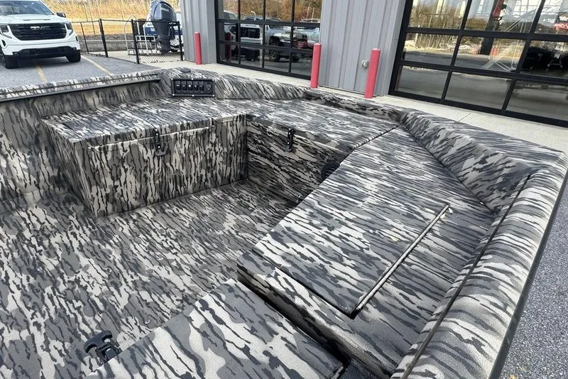 Slide: The Image of Camouflage interior of 2026 Havoc 1756 boat, featuring storage compartments and seating. - 8