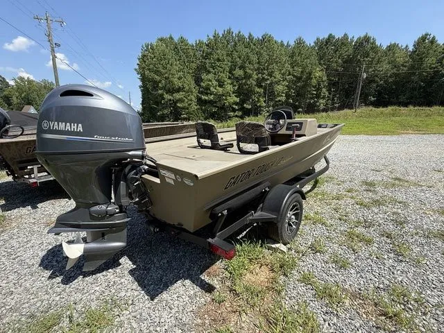 Slide: The Image of 2023 G3 Gator Tough 17 SC boat with Yamaha engine on gravel, surrounded by trees. - 3