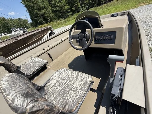 Slide: The Image of 2023 G3 Gator Tough 17 SC boat interior with camo seats and steering console. - 5