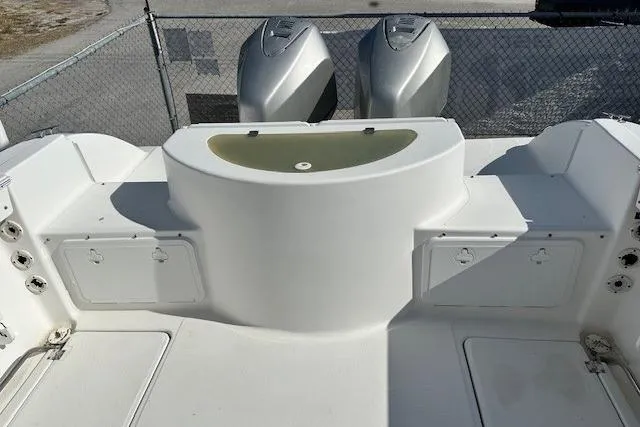 Slide: The Image of 2005 Sea Fox 287 Walkaround boat deck with dual engines and storage compartments. - 11