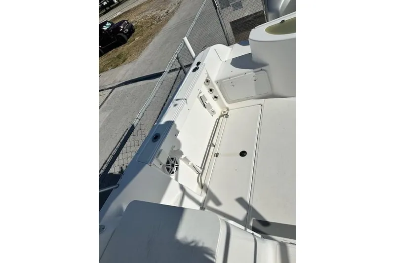 Slide: The Image of 2005 Sea Fox 287 Walkaround boat deck, featuring storage compartments and railing. - 12