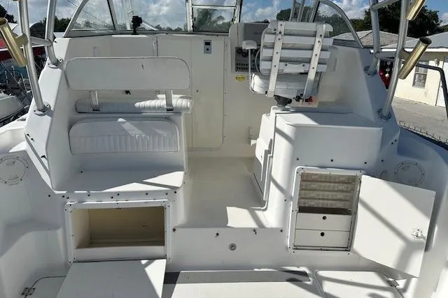 Slide: The Image of 2005 Sea Fox 287 Walkaround boat interior with seating and storage compartments. - 14