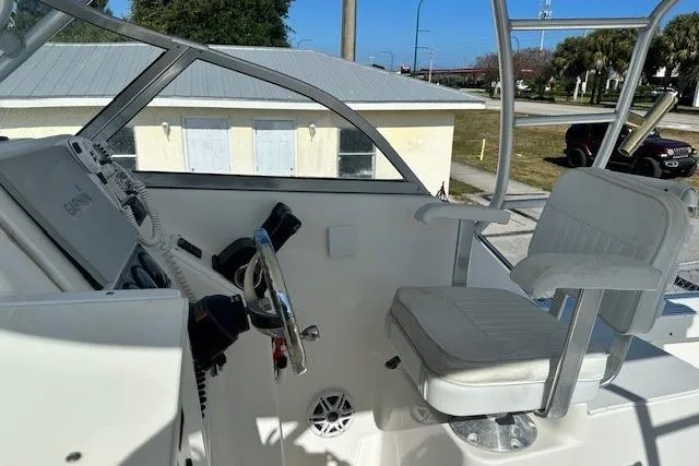 Slide: The Image of 2005 Sea Fox 287 Walkaround boat cockpit with steering wheel and seating. - 17
