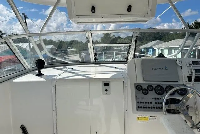 Slide: The Image of 2005 Sea Fox 287 Walkaround boat cockpit with Garmin navigation system and clear windshield. - 18