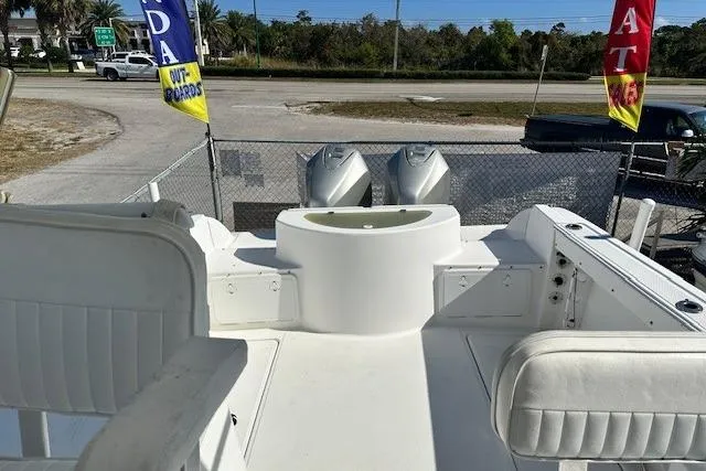 Slide: The Image of 2005 Sea Fox 287 Walkaround boat deck with seating and dual outboard motors. - 19