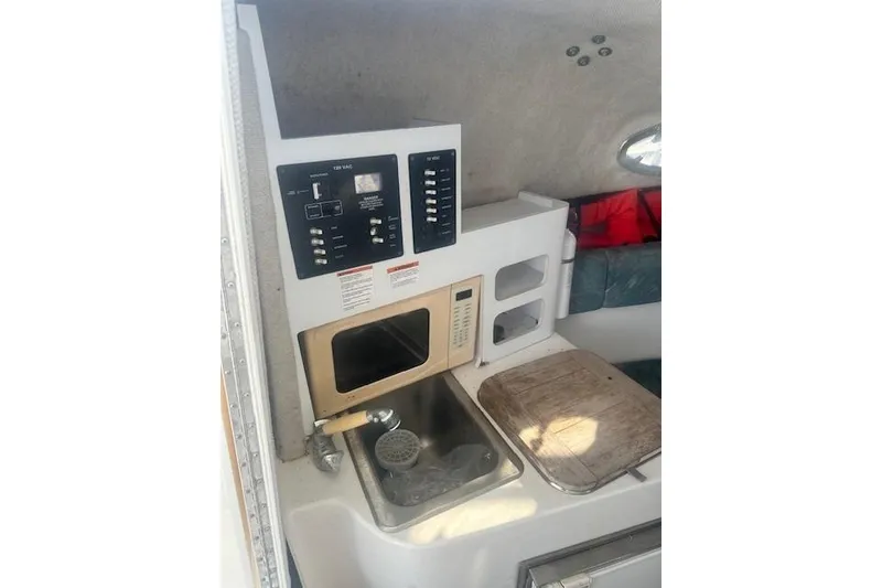 Slide: The Image of 2005 Sea Fox 287 Walkaround cabin interior with kitchenette and control panel. - 22