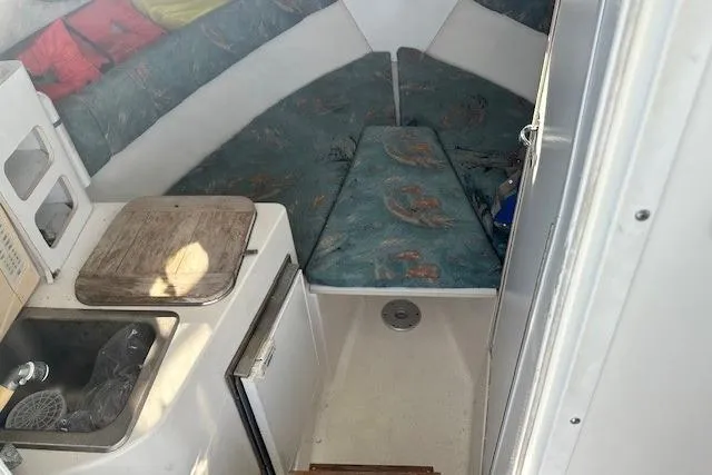 Slide: The Image of Interior cabin of a 2005 Sea Fox 287 Walkaround boat with kitchenette and sleeping area. - 24