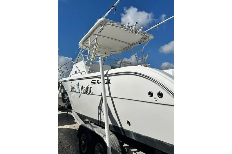 Slide: The Image of 2005 Sea Fox 287 Walkaround boat on trailer under blue sky. - 3